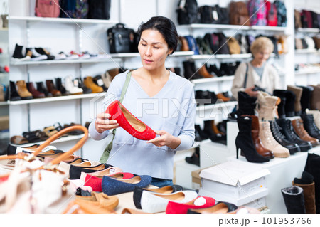 Focused Asian woman chooses ballet flats 101953766