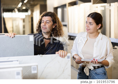 Husband and wife choose and buy ceramic flooring together 101953796
