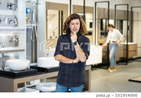 in plumbing department, man thought about choosing suitable bathroom for new apartment in plumbing department, man thought about choosing suitable bathroom for new apartment 101954000