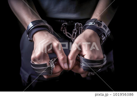 Handcuffed man in a jail, conceptual image of crime and punishment. Generative AI Handcuffed man in a jail, conceptual image of crime and punishment. Generative AI 101956386