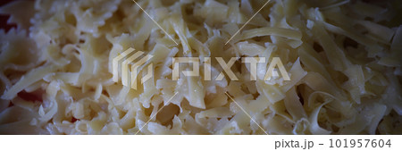 Yummy macaroni bow or farfalle pasta with grated cheese 101957604