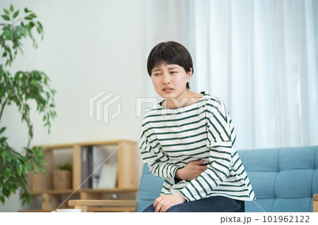腹痛でつらそうな女性 お腹が痛い女性 腹痛でつらそうな女性 お腹が痛い女性 101962122