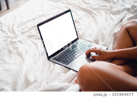 Laptop on empty bed,Caucasian woman laying on bed using laptop Laptop on empty bed,Caucasian woman laying on bed using laptop 101964877