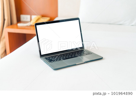 Laptop on empty bed,Caucasian woman laying on bed using laptop 101964890