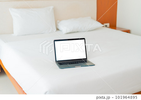 Laptop on empty bed,Caucasian woman laying on bed using laptop Laptop on empty bed,Caucasian woman laying on bed using laptop 101964895