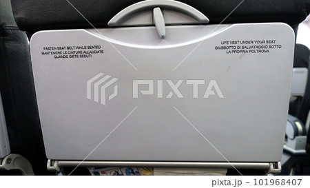 The back of an airplane seat. The back of an airplane seat. 101968407