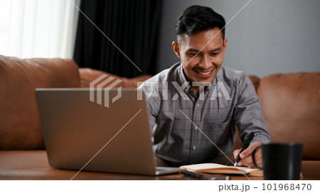 Happy millennial Asian businessman remote working at home 101968470