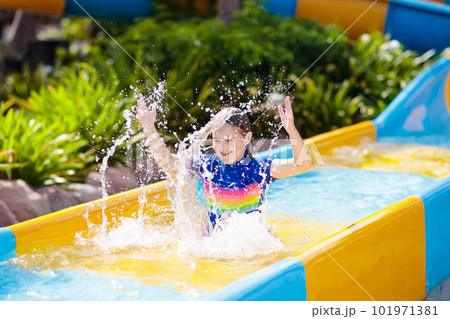 Kids on water slide in aqua park. Summer vacation 101971381
