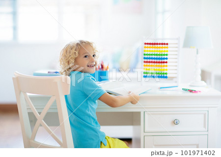 Child doing homework at home. 101971402