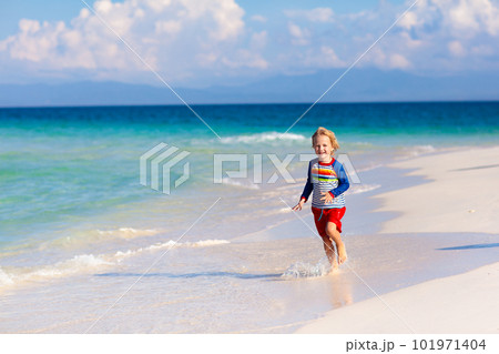 Kids playing on beach. Children play at sea. 101971404