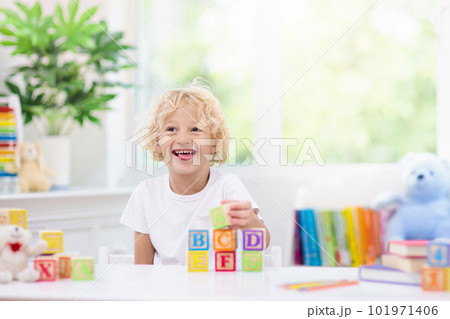 Child learning letters. Kid with wooden abc blocks Child learning letters. Kid with wooden abc blocks 101971406