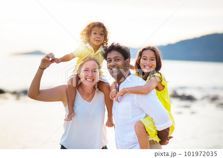 Family walking on tropical beach. Family walking on tropical beach. 101972035