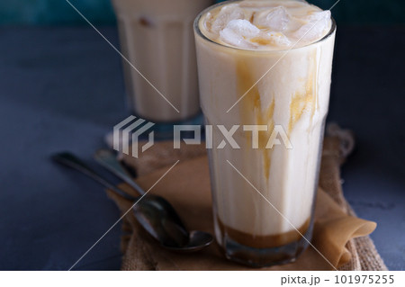 Iced coffee with milk in tall glasses 101975255