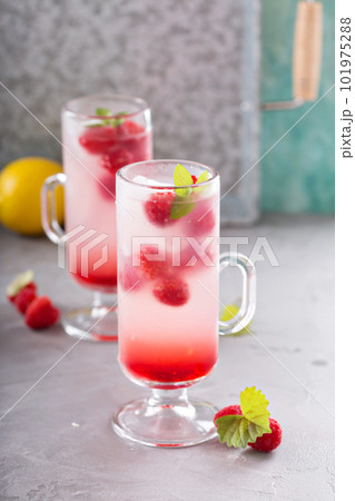 Pink raspberry lemonade in tall glasses Pink raspberry lemonade in tall glasses 101975288