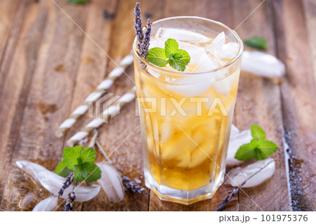 Lavender iced tea in tall glass 101975376