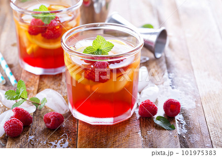 Red summer cocktail with lemons and raspberry 101975383