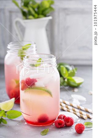 Cold green iced tea with lime and raspberry Cold green iced tea with lime and raspberry 101975444