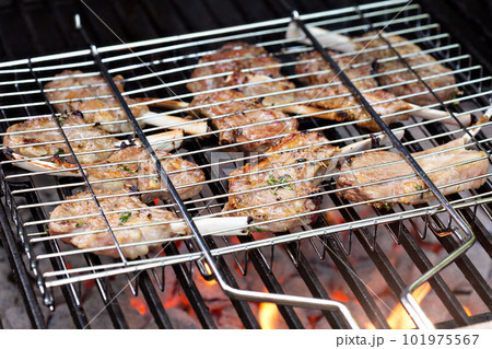 Lamb chops in grilling basket on grill 101975567