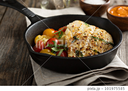 Grilled cod with tomato salad 101975585