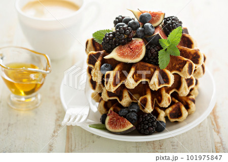 Fluffy breakfast waffles with fresh fruits 101975847