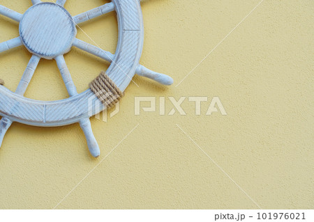 Vacation on yacht. White marine steering wheel on light background. Sea voyages and adventures. Promotional postcards. Vacation on yacht. White marine steering wheel on light background. Sea voyages and adventures. Promotional postcards. 101976021