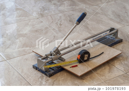Ceramic tiles and tools for tiler. Floor tiles installation. Home improvement, renovation - ceramic tile cutting tool. 101978193