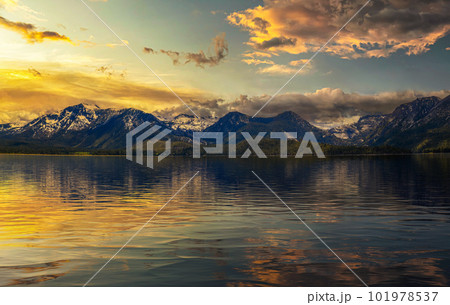 Summer sunset above Lake Tahoe with Sierra Nevada Mountains and reflection 101978537