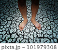 Bare feet on dried and cracked soil surface. 101979308
