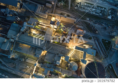 Aerial view of cement factory with high concrete plant structure and tower cranes at industrial production area at night. Manufacture and global industry concept. Aerial view of cement factory with high concrete plant structure and tower cranes at industrial production area at night. Manufacture and global industry concept. 101979782