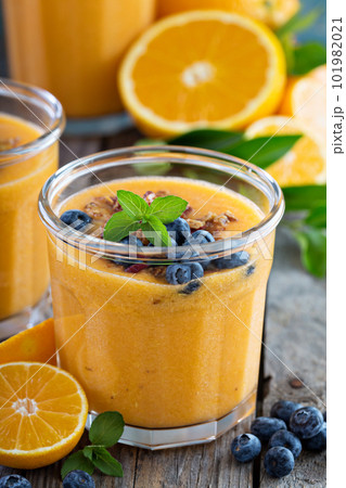 Orange and mango smoothie with granola Orange and mango smoothie with granola 101982021