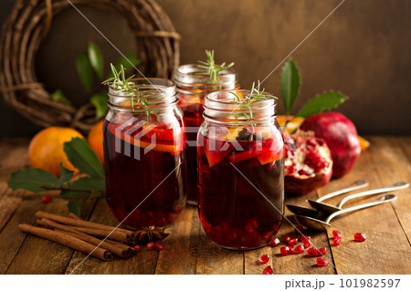 Pomegranate and orange winter cocktail Pomegranate and orange winter cocktail 101982597