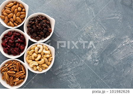 Variety of nuts and dried fruits in small bowls Variety of nuts and dried fruits in small bowls 101982626
