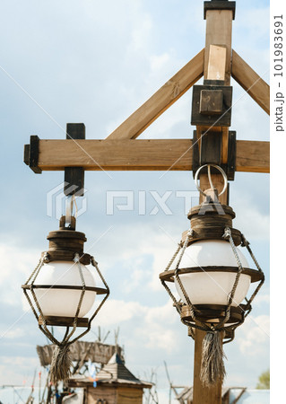 Old wooden lanterns hanging on a wooden pole 101983691
