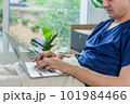 Caucasian patient using laptop in hospital room. man sick patient lying in a hospital bed 101984466