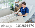 Caucasian patient using laptop in hospital room. man sick patient lying in a hospital bed 101984470