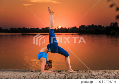yoga at sunset on the beach. yoga at sunset on the beach. 101990814