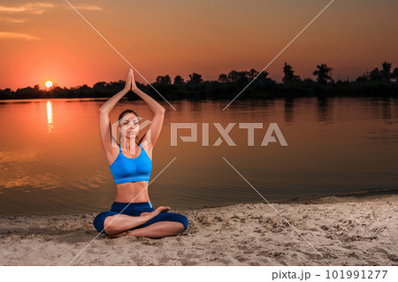 yoga at sunset on the beach. 101991277
