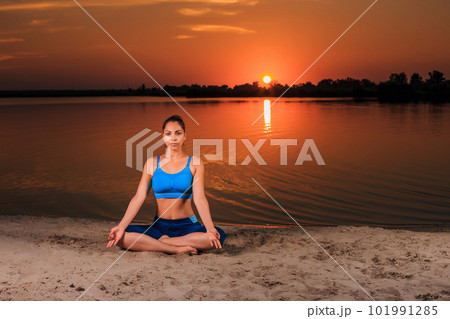 yoga at sunset on the beach. yoga at sunset on the beach. 101991285