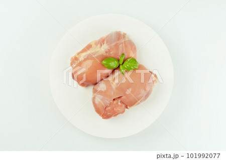 Ogranic food,healthy eating.Food concept.Top view.Raw fresh skinless chicken thigh meat with fresh herbs on a white background.Copy space.Food for retail. 101992077