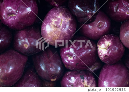 Stack of eggplants on a market stall Stack of eggplants on a market stall 101992938