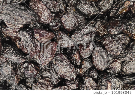 Stack of organic dried plums in a market stall Stack of organic dried plums in a market stall 101993045