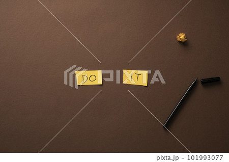 Do It sign spelled on two yellow papers Do It sign spelled on two yellow papers 101993077