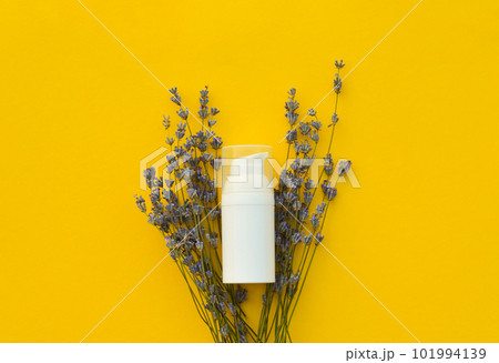 Flat lay organic lavender flowers, moisturizer cream on yellow background. The concept of beauty and wellness. Skincare and body Flat lay organic lavender flowers, moisturizer cream on yellow background. The concept of beauty and wellness. Skincare and body 101994139