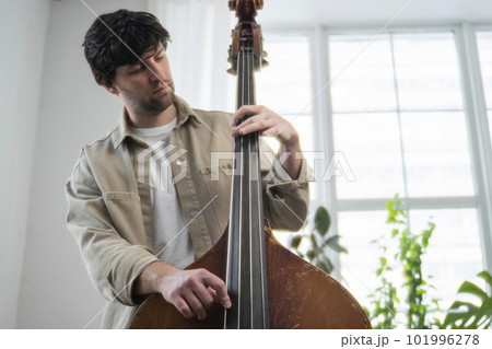 Double bass. Hands playing contrabass player musical instrument Double bass. Hands playing contrabass player musical instrument 101996278