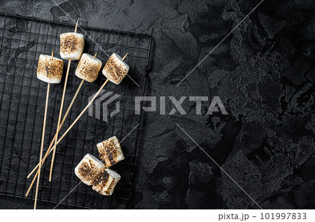 BBQ Grilled Marshmallow on the sticks. Black background. Top view. Copy space BBQ Grilled Marshmallow on the sticks. Black background. Top view. Copy space 101997833