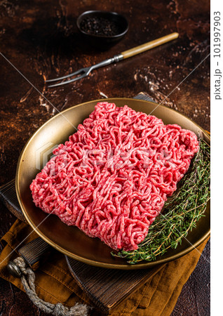 Fresh mutton lamb Mince Meat, raw ground meat. Dark background. Top view Fresh mutton lamb Mince Meat, raw ground meat. Dark background. Top view 101997903