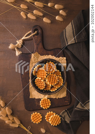 Waffer cookies on ceramic bowl 102002144