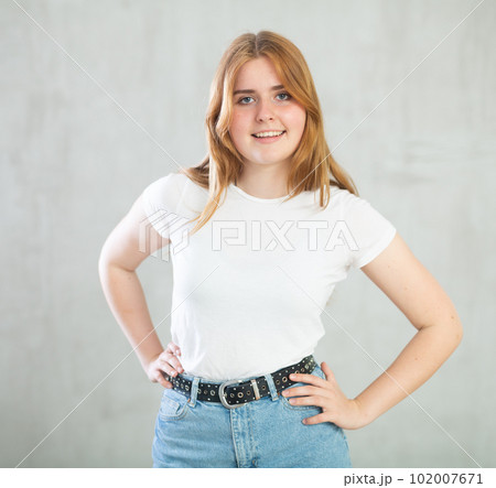 Portrait of beautiful cute cheerful girl smiling looking at camera over grey background Portrait of beautiful cute cheerful girl smiling looking at camera over grey background 102007671