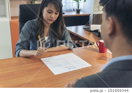 Businessman job interview by human resource HR officer interviwing, talk new employee shaking hands in office with smiling face. HR Manager interview check resume, face to face. Job Interview Concept 102009344