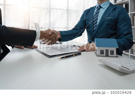 real estate agent shaking hand his client after signing contract,concept for real estate, moving home or renting property real estate agent shaking hand his client after signing contract,concept for real estate, moving home or renting property 102010426